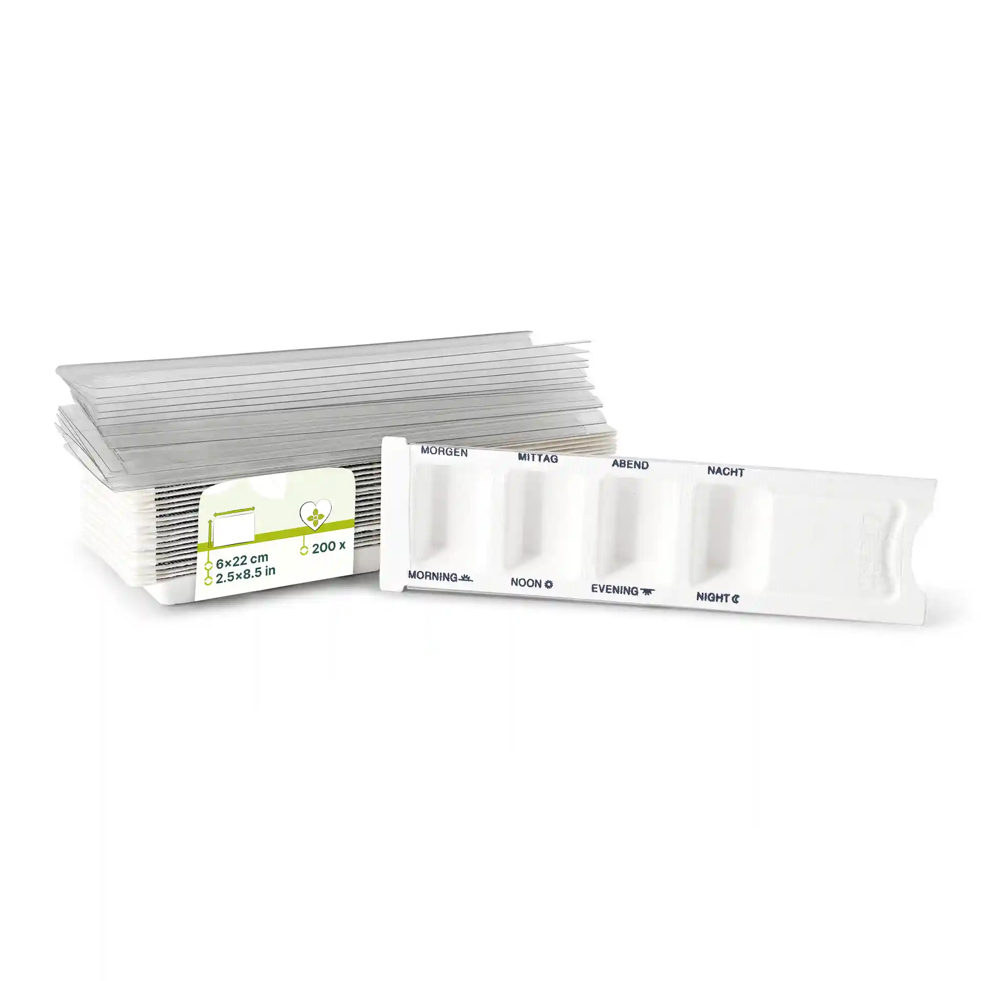 Witte rechthoekige medicijndispenser met vier compartimenten en een schuifdeksel, naast een stapel transparante vellen.