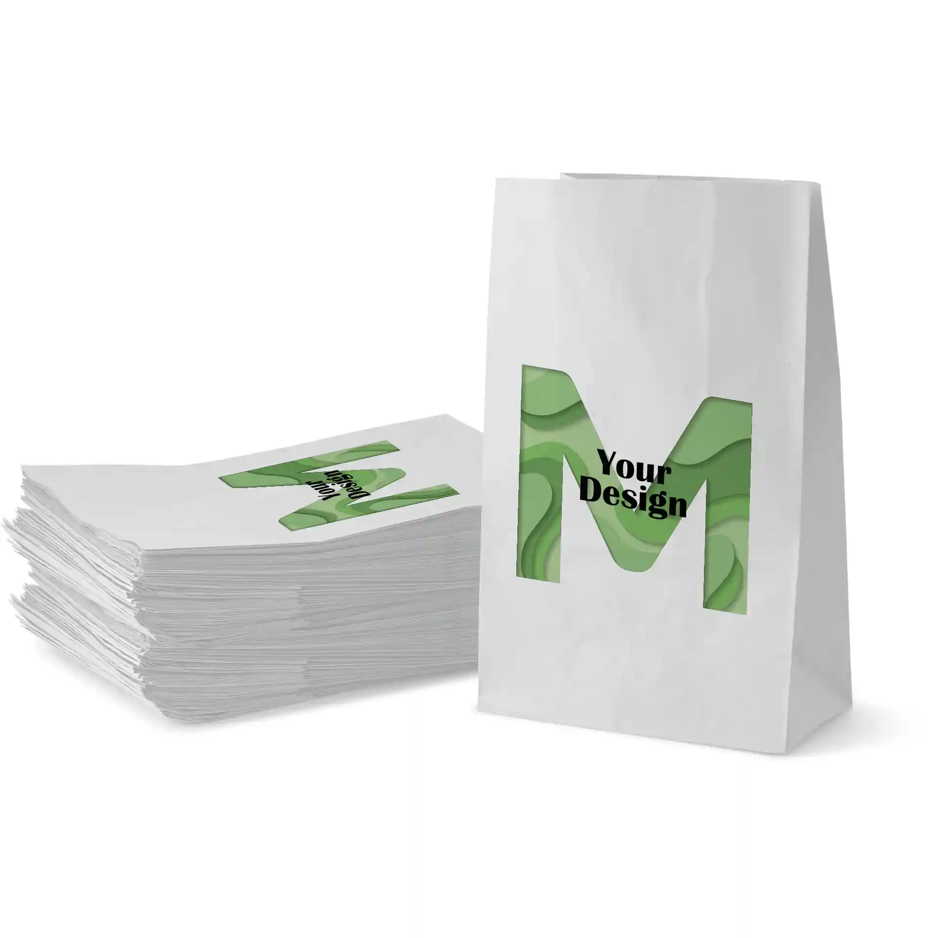 Witte papieren tas met een groen ontwerp met de letter 'M' en de tekst 'Jouw Ontwerp', gestapeld met vergelijkbare tassen.